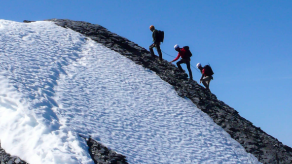 Hikers climbing to the top of the mountain